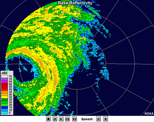 Radar reflectivity loop showing hurricane Wilma making landfall in 2005. The eye, which is free of echo, is large and pronounced. Bands of moderate to high reflectivity values encircle the eye, and other intense bands of precipitation can be seen spiraling outward from the storm's center.