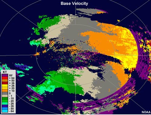 Radial velocity loop showing winds moving toward the radar on the left side of the image and away from the radar on the right.  A small area to the southwest of the radar shows an initially divergent couplet that expands in size with time.